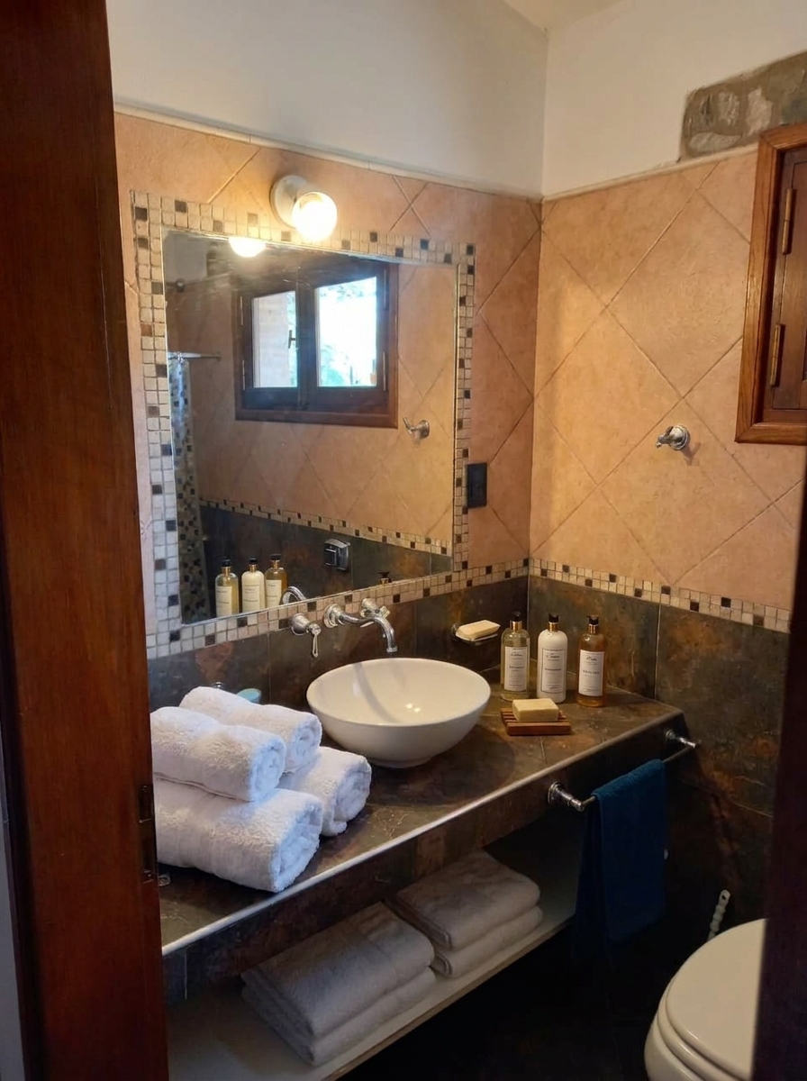 Tocador de baño privado con jabón, toallas y amenities en Casa Quinta Cruz del Eje, Córdoba